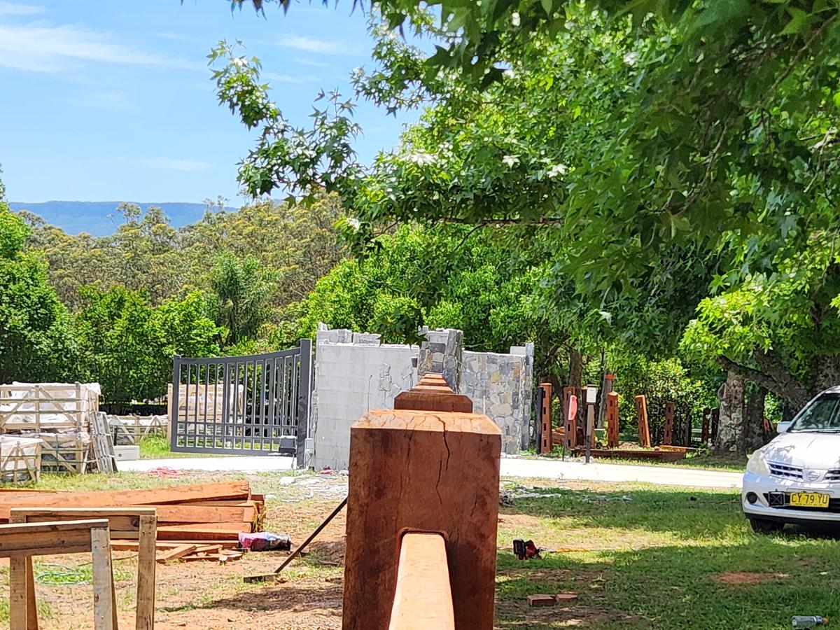 Close view of a hardwood post cap with a rail let into the face