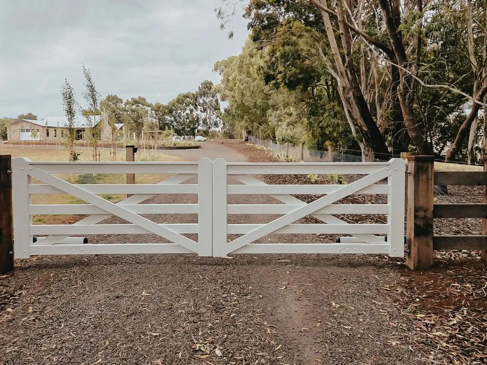 White timber entry gates hung between hardwood posts