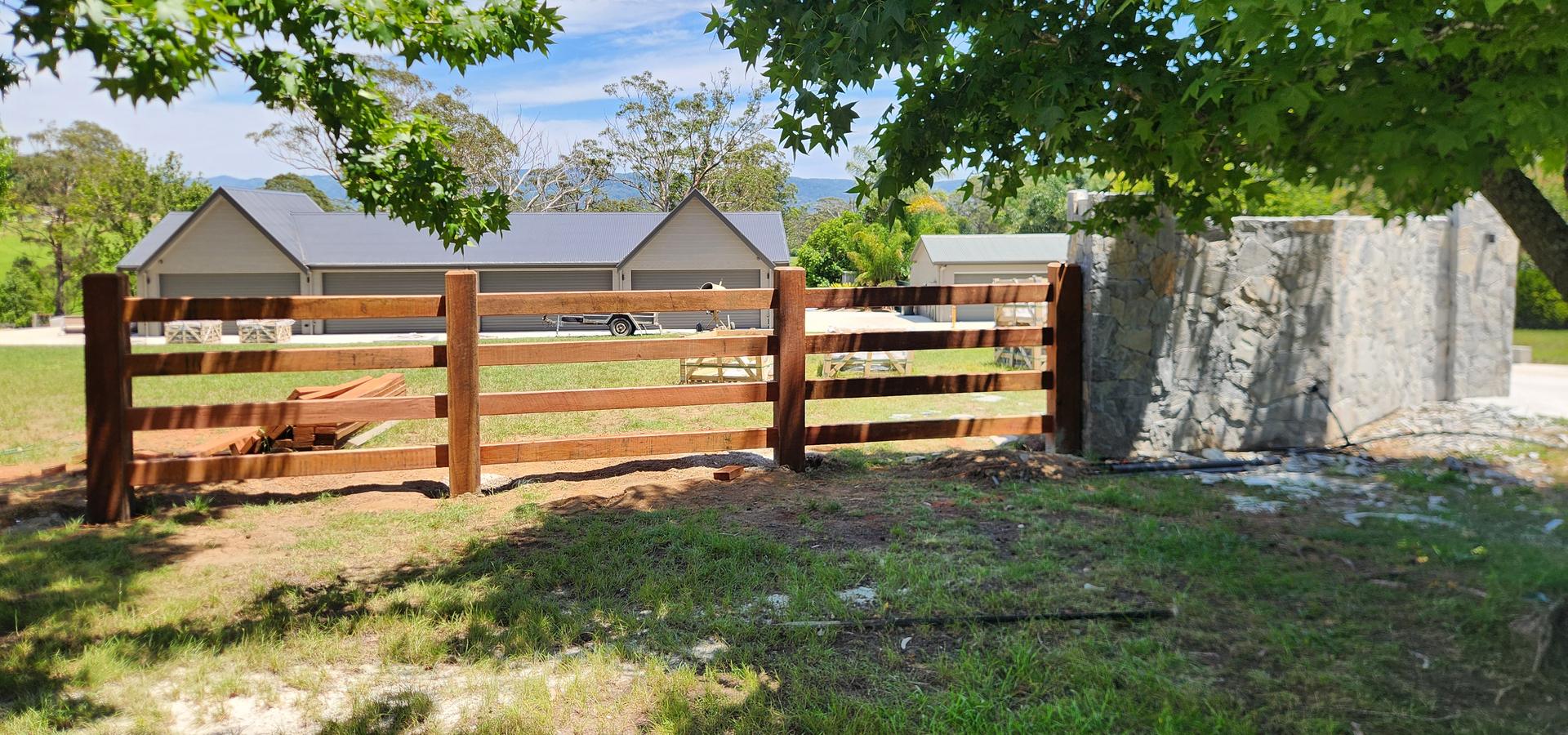 Timber post and rail fence on acreage